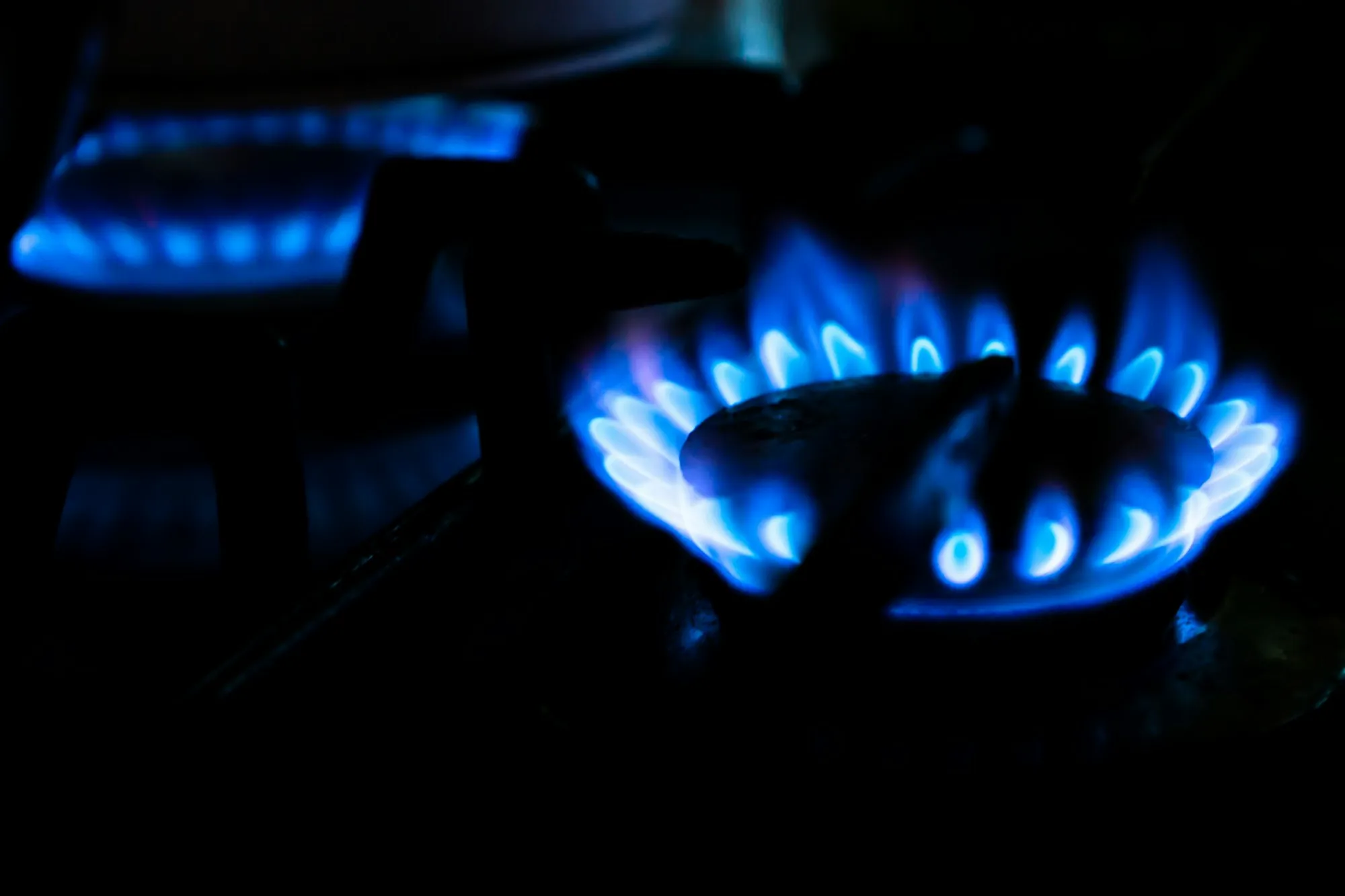 Ring of blue gas flames in the dark