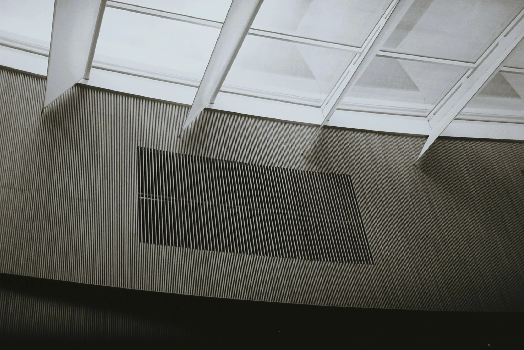 Long linear air vent grille in a ceiling